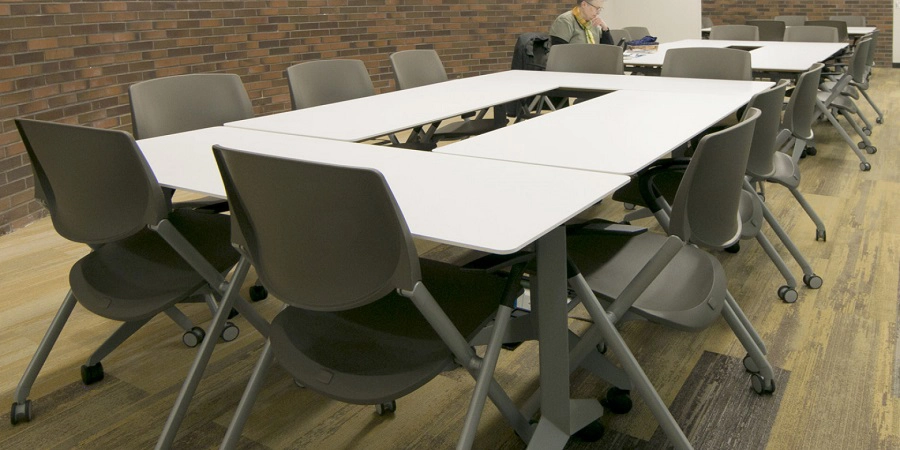 Laptop pull-up tables beside lounge seating