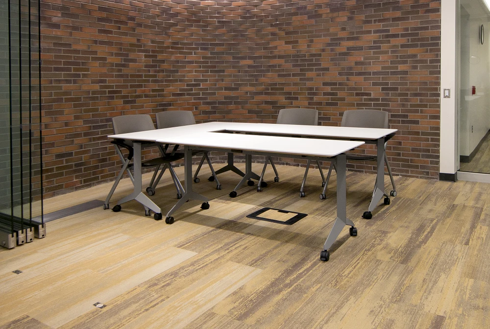 Laptop pull-up tables beside lounge seating